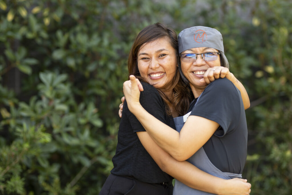 food and support services team members hugging