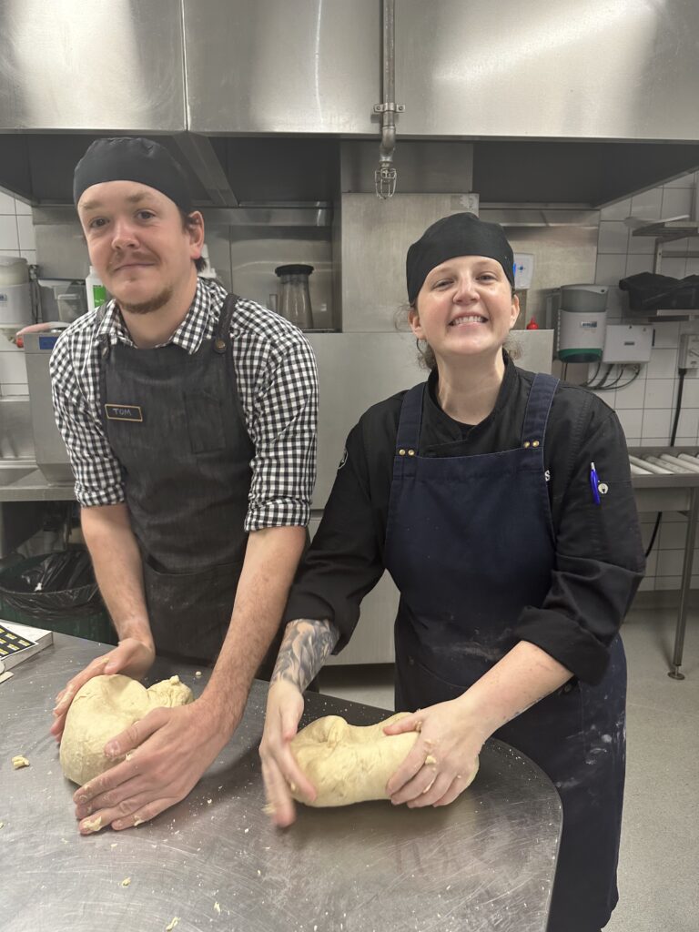 Sam Green in the kitchen kneading bread