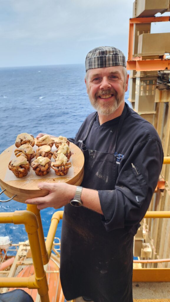 Colin holding a plate on muffins on site