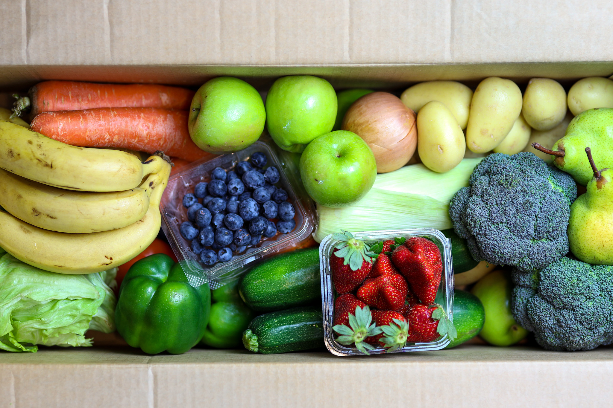 Essentials Box||Team packing boxes|Team packing boxes|Team packing boxes|Team delivering Essentials Boxes|Person receiving Essentials Box