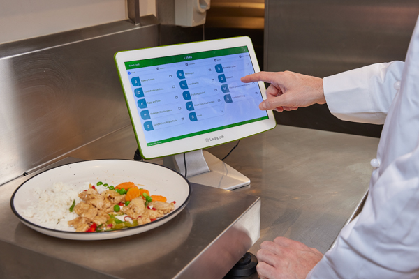 Person measuring food waste with LeanPath technology